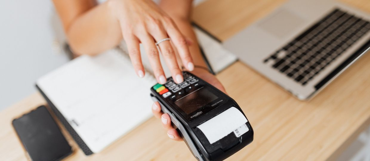 shop counter with a laptop and paper receipts