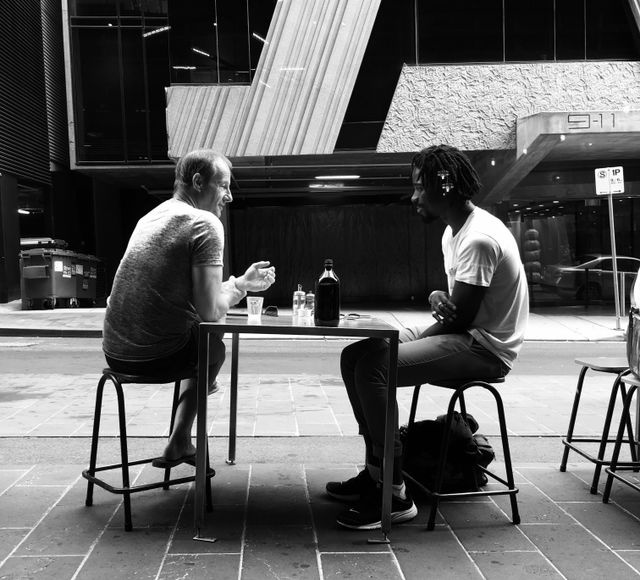 business coach and owner talking at a cafe table