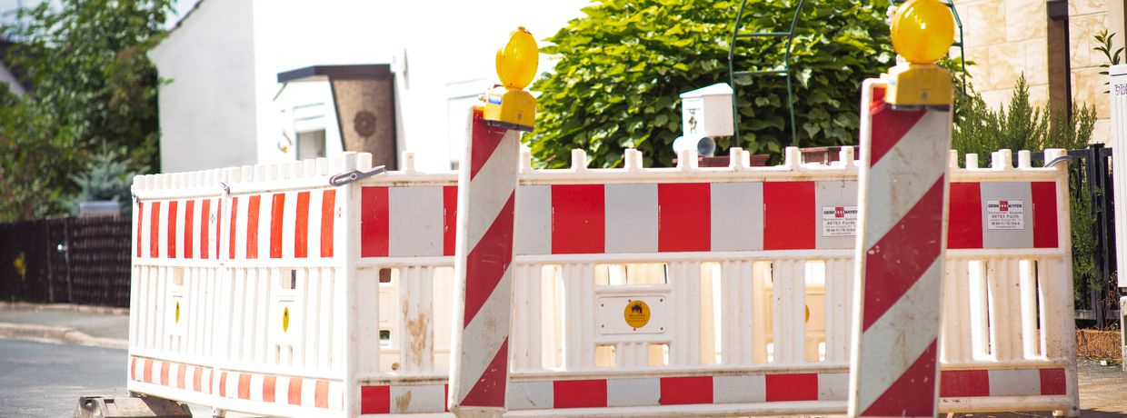 empty suburban street with road works barrier