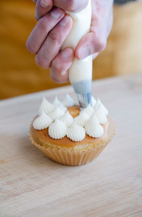 cupcake cases and piping bag on a kitchen bench