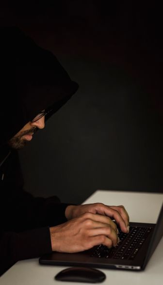 person typing on laptop with cyber security lock