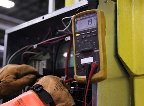 electrician testing circuit breaker panel