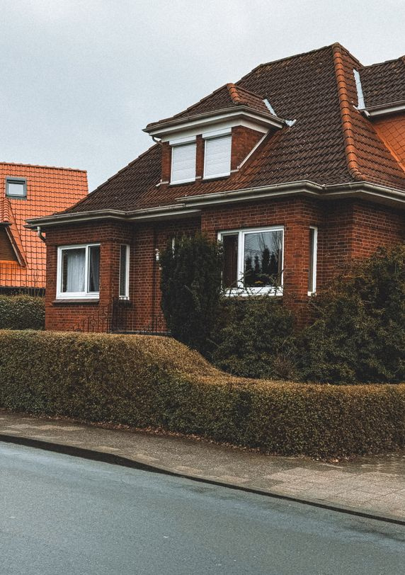brick family home exterior with front garden