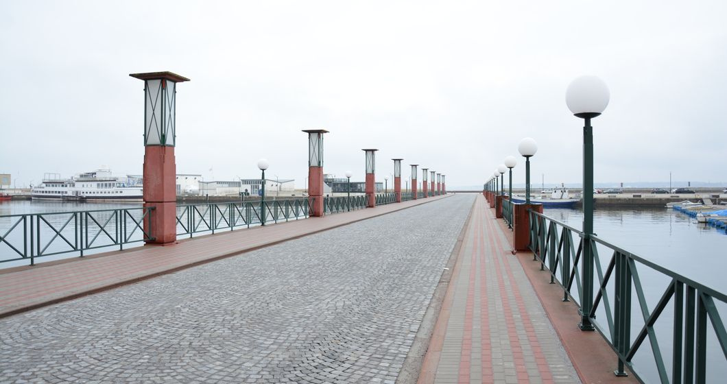empty waterfront promenade path at sunrise