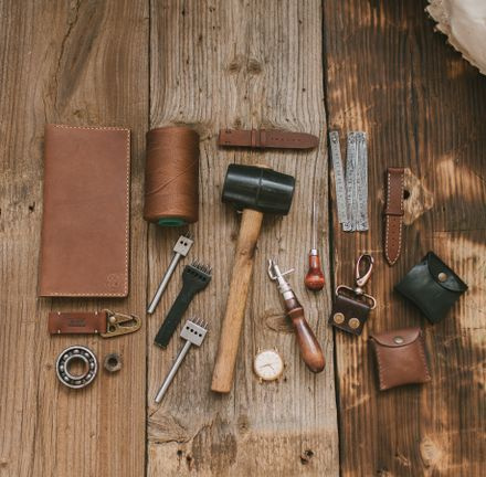 leather tool belt with carpenter tools on table
