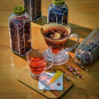 herbal tea with glass jars of dried flowers