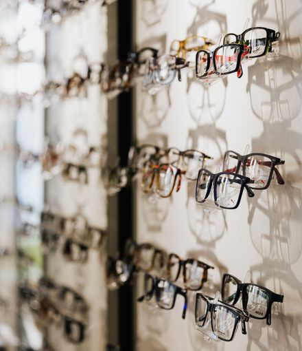 eyeglasses frames displayed on wall optical store