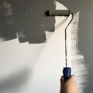painter roller painting wall