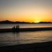 family silhouette on beach at sunset