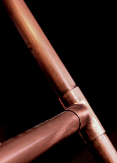 copper pipe fittings on a workbench