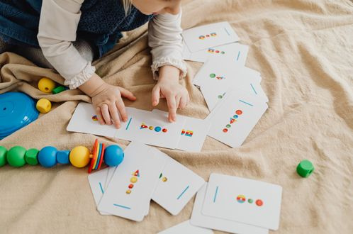 child playing educational cards