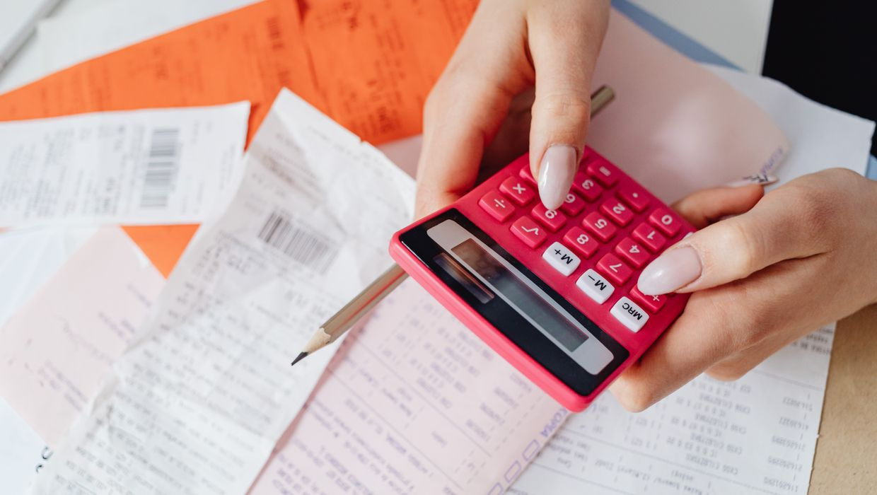 calculator on a pile of receipts and tax papers