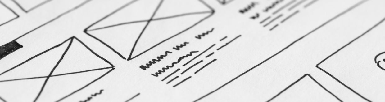 hand drawing website wireframe sketch on paper with pencil